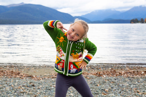 Kids playing outdoors in colourful Peruvian knitwear, Chicha NZ ages 3-4