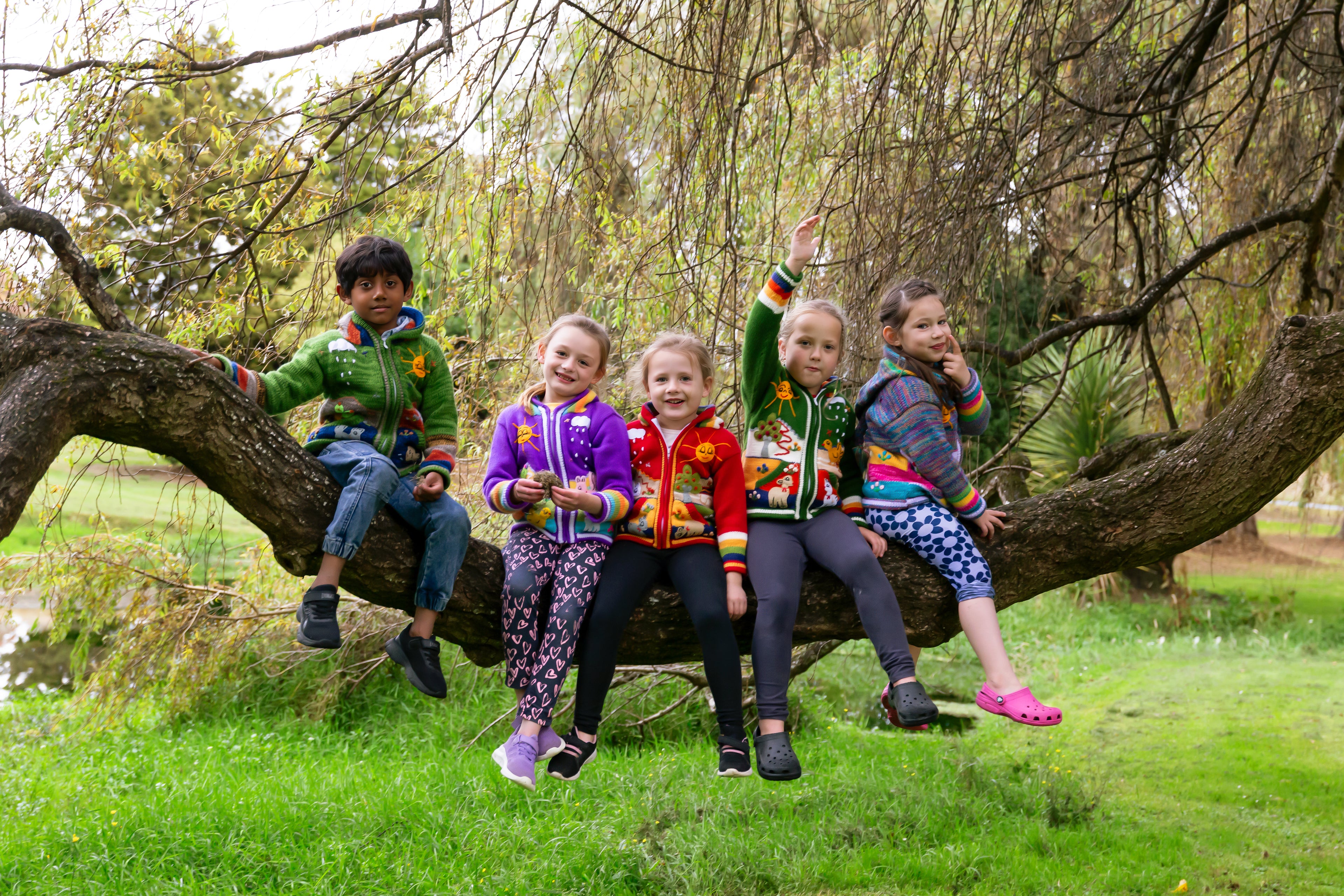 Child wearing handmade Peruvian jumper ages 0-8, Fiordland New Zealand